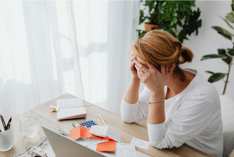 woman upset alone at her desk representing How Emotional Eating Affects Relationships and How to Heal