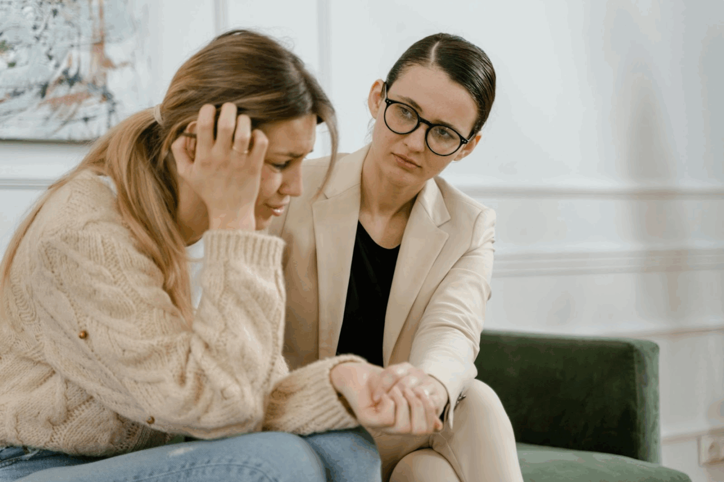 A therapist offers support to a visibly distressed woman during a counseling session. This image represents the emotional toll of navigating diet culture and the importance of having compassionate support when setting boundaries around food and body talk.