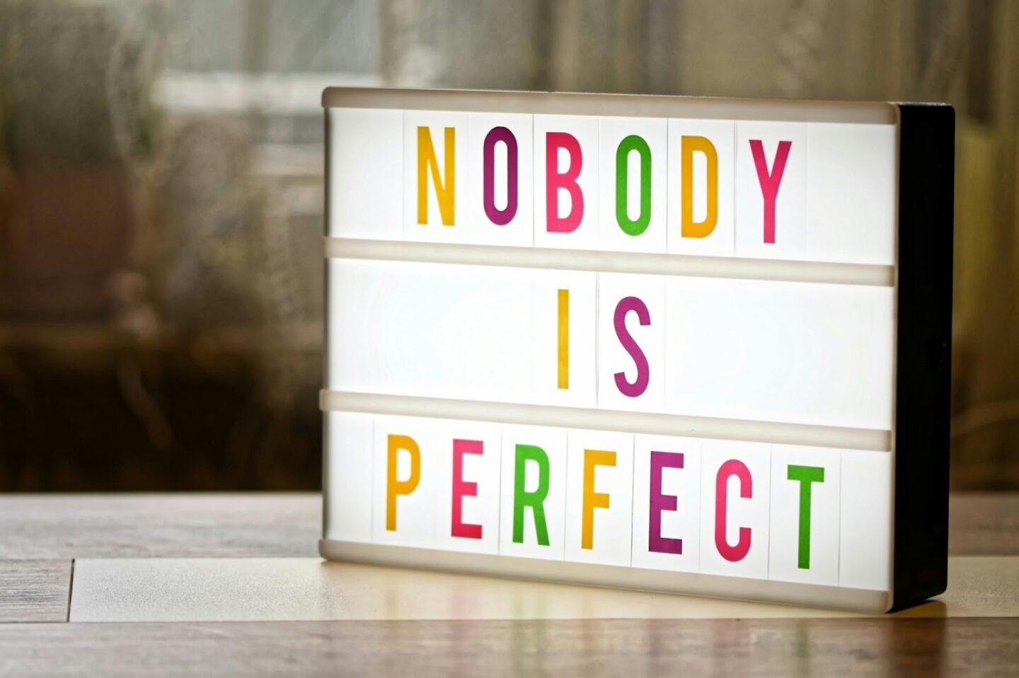Lightbox sign that says “NOBODY IS PERFECT,” reflecting self-compassion and flexibility during the recovery process.